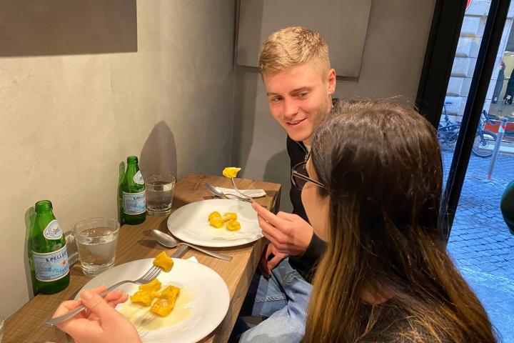 a person sitting at a table with a plate of food